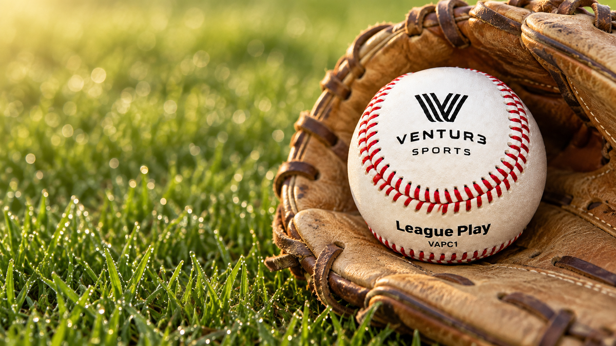 A VAPC1 baseball in the pocket of a worn youth glove on dewy grass